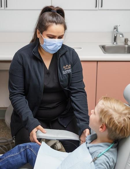A registered dental hygienist working with a child