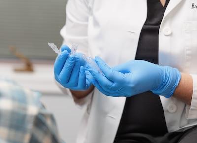 Dr Mooney holding two Invisalign trays