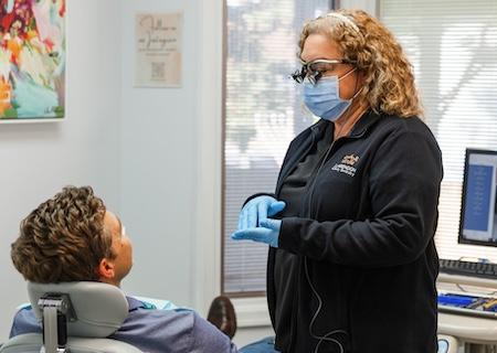 A dental patient speaking to his dental hygienist in Arlington, VA